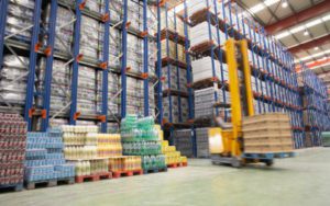 Inside a CJR warehouse a forklift loads boxes of food