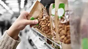 Grocery shopper choosing nuts for healthy snacking